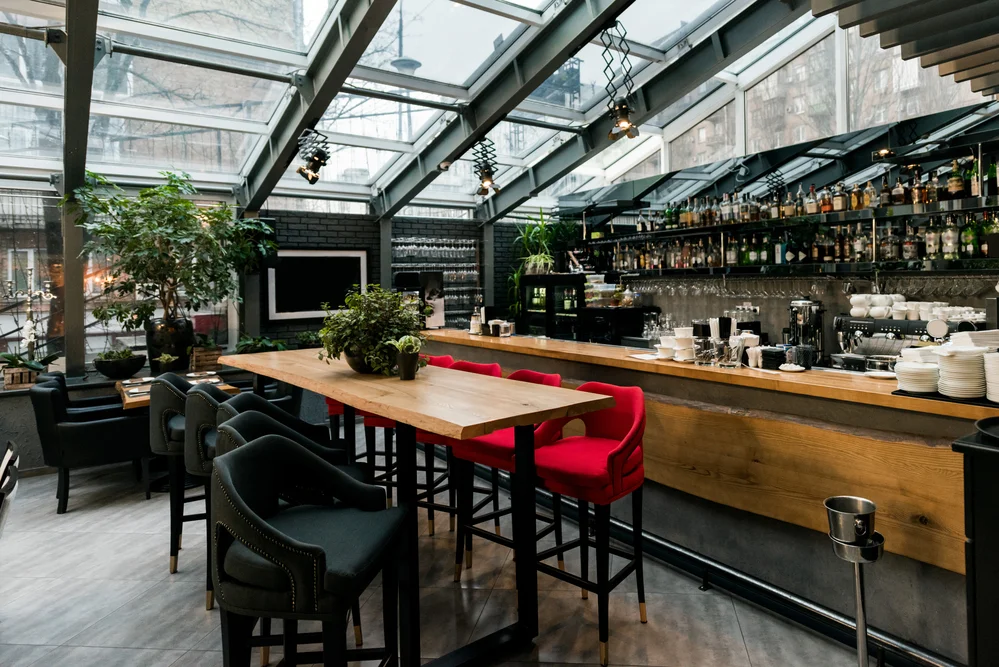 A stylish empty cafe with tables arranged to welcome customers