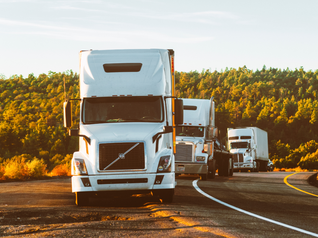 A fleet of trucks stopped along a highway, highlighting the impact of poor data quality on fleet optimisation and the need for accurate, reliable telematics data