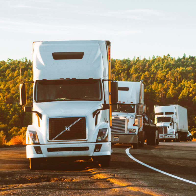 A fleet of trucks stopped along a highway, highlighting the impact of poor data quality on fleet optimisation and the need for accurate, reliable telematics data