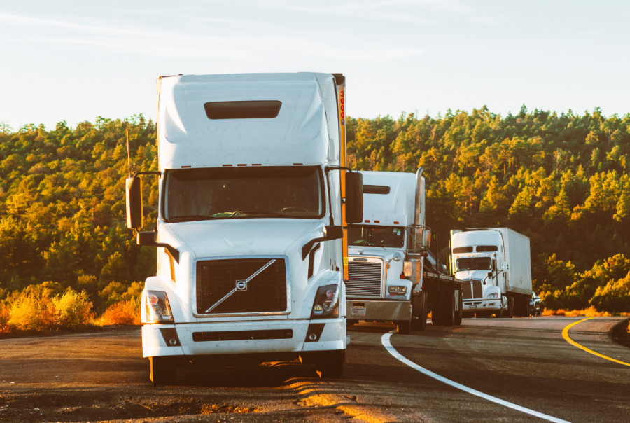 A fleet of trucks stopped along a highway, highlighting the impact of poor data quality on fleet optimisation and the need for accurate, reliable telematics data