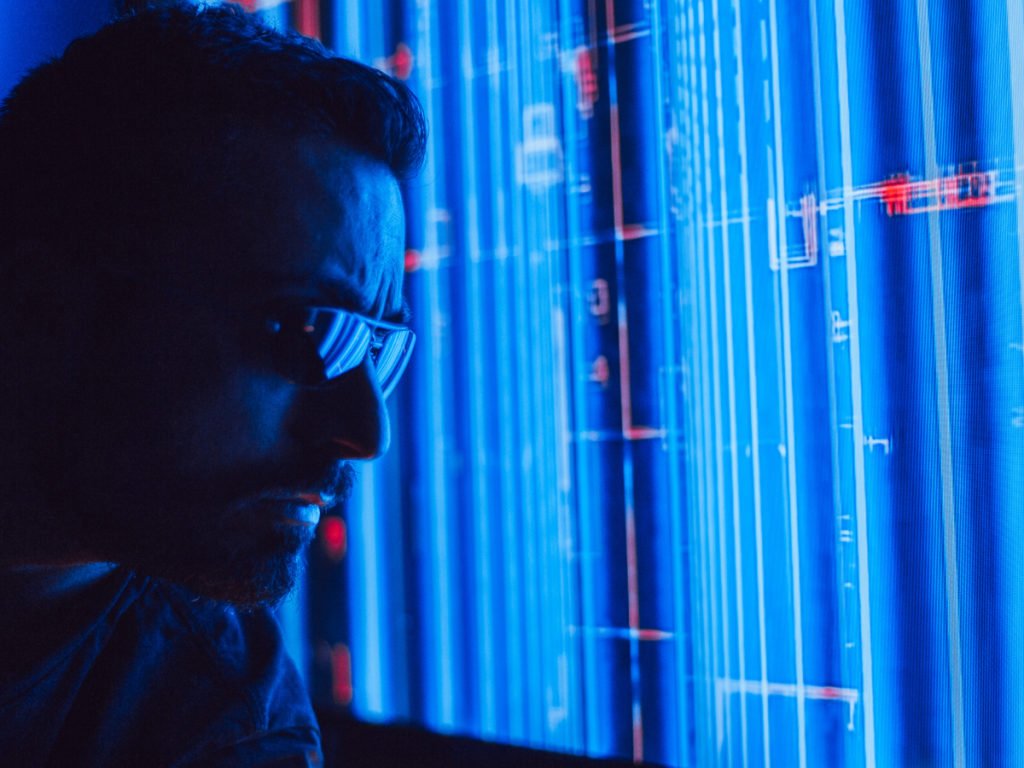 A man inspecting a data dashboard that visualises compliance workflow automation across multiple sites