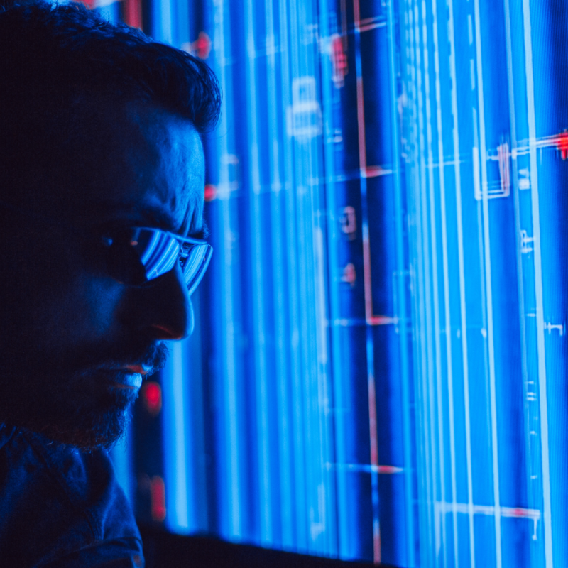 A man inspecting a data dashboard that visualises compliance workflow automation across multiple sites