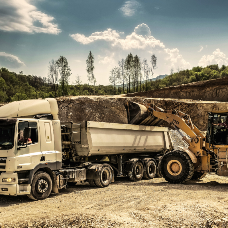 A construction truck and machinery in an open construction zone