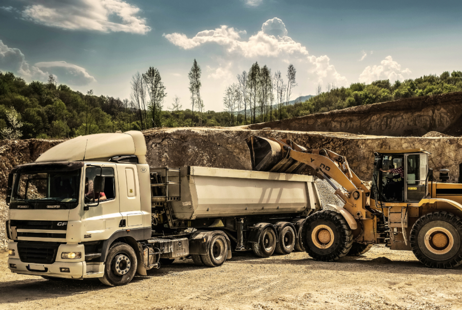 A construction truck and machinery in an open construction zone