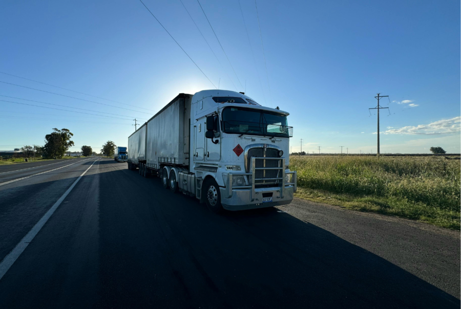 Trucks en route are parked on the verge in a quiet country road.