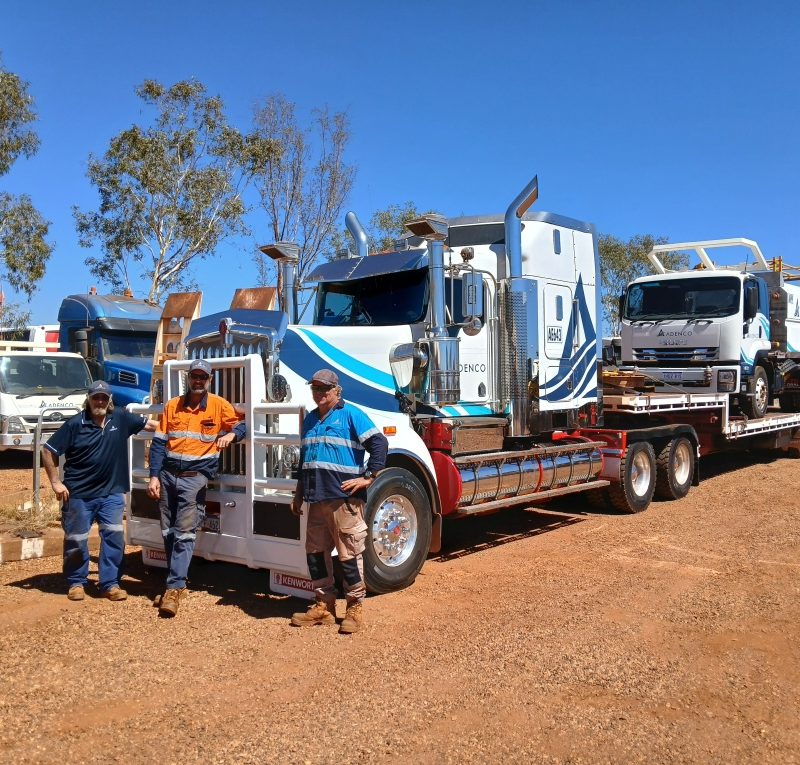 Damian Saraber and the team from Adenco standing in front of mining equipment, representing the company’s use of an integrated asset tracking solution for mining