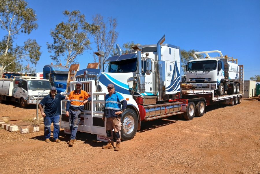Damian Saraber and the team from Adenco standing in front of mining equipment, representing the company’s use of an integrated asset tracking solution for mining