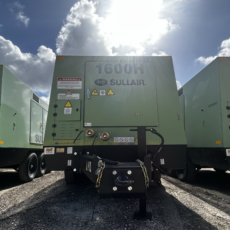 Three Sullair 1600H portable air compressors lined up outdoors, highlighting equipment that can be monitored via a fleet management dashboard for real-time condition tracking and maintenance management
