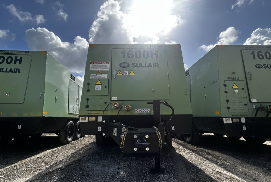 Three Sullair 1600H portable air compressors lined up outdoors, highlighting equipment that can be monitored via a fleet management dashboard for real-time condition tracking and maintenance management